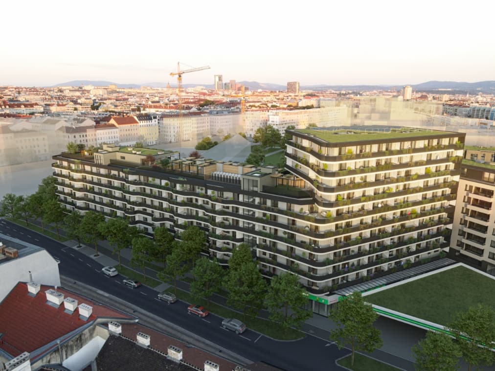 Großes Wohngebäude mit begrünten Terrassen bei Abendlicht