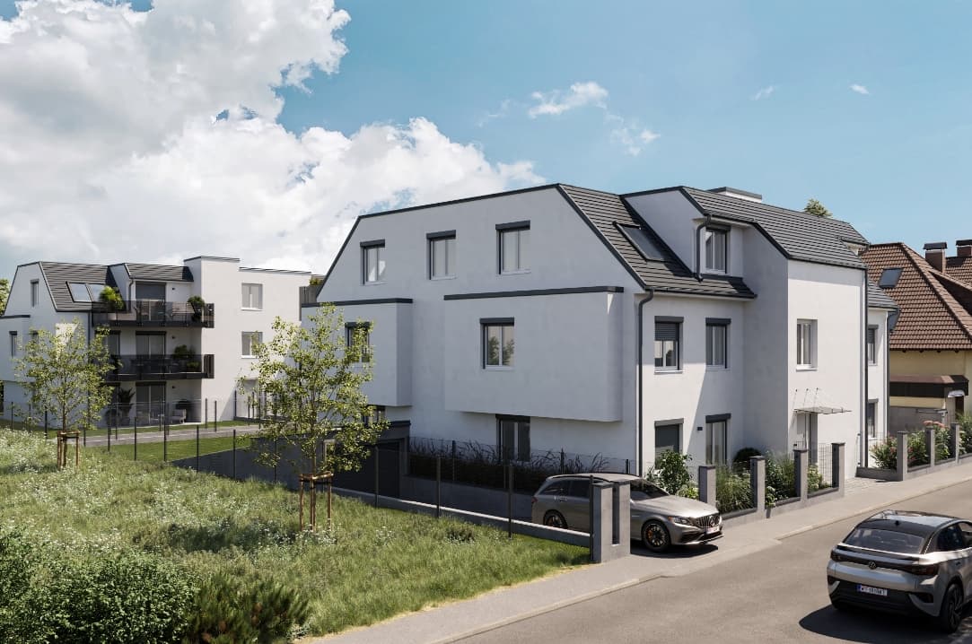 Modernes Mehrfamilienhaus mit Balkonen an einer Vorstadtstraße